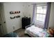 Bright bedroom features a metal bed, a large window, and soft purple accents, creating a cozy and inviting space at 4565 Deerfield Dr, Cumming, GA 30028