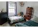 Cozy bedroom with a metal bed, soft lighting, and plush decor, creating a comfortable and inviting space at 4565 Deerfield Dr, Cumming, GA 30028