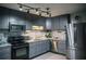 Modern kitchen with stainless steel appliances, granite countertops, and stylish backsplash at 4565 Deerfield Dr, Cumming, GA 30028