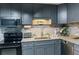 Beautiful kitchen with grey cabinets, granite countertops, and stainless steel dishwasher at 4565 Deerfield Dr, Cumming, GA 30028
