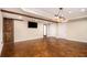 Finished basement with stained floors, wooden beam, and accent lighting at 6350 Old Wood Hollow Way, Buford, GA 30518