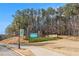 Stone sign for Lanier Islands community with lush landscaping at 6350 Old Wood Hollow Way, Buford, GA 30518