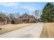 Beautiful brick home with a well-manicured front lawn and a long driveway at 6350 Old Wood Hollow Way, Buford, GA 30518