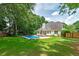 Expansive backyard with a refreshing in-ground pool and lush landscaping for outdoor enjoyment at 90 Barrington Grange Dr, Sharpsburg, GA 30277