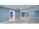 Finished basement featuring light blue walls, drop ceiling, and wood-look laminate flooring at 90 Barrington Grange Dr, Sharpsburg, GA 30277