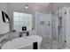 Modern bathroom with soaking tub and separate glass-enclosed shower at 90 Barrington Grange Dr, Sharpsburg, GA 30277