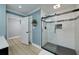 Bathroom featuring glass enclosed shower, double doors, and grey tiled floors at 90 Barrington Grange Dr, Sharpsburg, GA 30277
