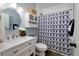 Cozy bathroom with a single vanity and a shower with patterned curtain at 90 Barrington Grange Dr, Sharpsburg, GA 30277