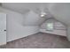 Attic bedroom featuring a built-in window seat, shelves and carpeted floor at 90 Barrington Grange Dr, Sharpsburg, GA 30277