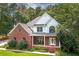 Charming two-story brick home with a well-manicured lawn and inviting front porch at 90 Barrington Grange Dr, Sharpsburg, GA 30277