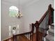 Bright foyer with hardwood floors, staircase, elegant chandelier, and front door with decorative wreath at 90 Barrington Grange Dr, Sharpsburg, GA 30277