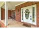 Inviting front porch with brick accents and a welcoming entrance at 90 Barrington Grange Dr, Sharpsburg, GA 30277