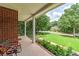 Charming front porch of a brick home with a view of the front yard and neighborhood at 90 Barrington Grange Dr, Sharpsburg, GA 30277