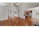 Large living room with vaulted ceilings, hardwood floors, and an open floor plan to the kitchen and dining room at 90 Barrington Grange Dr, Sharpsburg, GA 30277