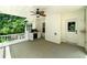 Covered deck with fan, outdoor grill, and a peaceful setting for outdoor enjoyment at 90 Barrington Grange Dr, Sharpsburg, GA 30277