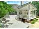 Spacious back deck offers a relaxing outdoor space with a built-in bench and lovely landscaping at 90 Barrington Grange Dr, Sharpsburg, GA 30277