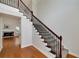 Elegant staircase featuring iron railings, wood steps, and a view of the living room at 90 Barrington Grange Dr, Sharpsburg, GA 30277