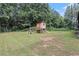 Large backyard with a custom-built treehouse and playground equipment at 140 Indian Lake Dr, Hiram, GA 30141