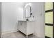Modern bathroom features a white vanity with a black faucet and an arch mirror at 140 Indian Lake Dr, Hiram, GA 30141