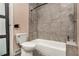 View of bathroom featuring toilet and tiled bathtub with shower head at 140 Indian Lake Dr, Hiram, GA 30141