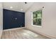 Well-lit bedroom featuring modern flooring and a large window at 140 Indian Lake Dr, Hiram, GA 30141