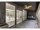 View of the covered patio showcasing a cushioned bench, ceiling fan, and dark painted wood at 140 Indian Lake Dr, Hiram, GA 30141