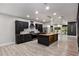 Open-concept kitchen with stainless steel appliances, island with sink, and custom cabinetry at 140 Indian Lake Dr, Hiram, GA 30141