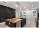 Kitchen with stainless steel appliances, wooden island with sink, and modern pendant lighting at 140 Indian Lake Dr, Hiram, GA 30141