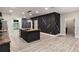 Modern kitchen with an island, stainless steel appliances, and a unique dark accent wall at 140 Indian Lake Dr, Hiram, GA 30141