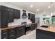 Kitchen featuring stainless steel appliances, dark cabinets, and a wooden island with bar seating at 140 Indian Lake Dr, Hiram, GA 30141