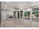 Spacious living room with hardwood floors, recessed lighting, fireplace, and screened-in porch at 140 Indian Lake Dr, Hiram, GA 30141