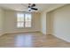 Sun-filled, empty bedroom featuring light hardwood floors and a modern ceiling fan at 1456 S Gordon Sw St, Atlanta, GA 30310