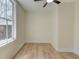 Bright bedroom features hardwood flooring, large window, and fresh white trim at 1456 S Gordon Sw St, Atlanta, GA 30310
