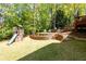 Beautifully terraced backyard with a playset and outdoor seating perfect for entertaining at 4016 Upland Trce, Marietta, GA 30066