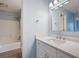 A bathroom with a white sink and vanity, mirror and tub/shower combo with nice lighting at 4016 Upland Trce, Marietta, GA 30066