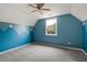 A blue painted bedroom with a light-colored carpet, a window, and a ceiling fan at 4016 Upland Trce, Marietta, GA 30066