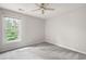 A bedroom with gray carpet, a window with a view of trees, and ceiling fan at 4016 Upland Trce, Marietta, GA 30066