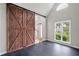 Bonus room with dark tile floors, statement sliding barn door, and bright window at 4016 Upland Trce, Marietta, GA 30066