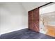 Bonus room featuring dark tile floors and a sliding barn door to a living area at 4016 Upland Trce, Marietta, GA 30066
