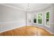 Formal dining area with crown molding, wainscoting, hardwood floors and ample natural light at 4016 Upland Trce, Marietta, GA 30066