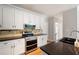 Updated kitchen featuring stainless appliances, granite countertops, and white cabinets at 4016 Upland Trce, Marietta, GA 30066