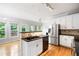 Open kitchen with stainless steel appliances, black countertops and hardwood floors at 4016 Upland Trce, Marietta, GA 30066