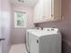 A laundry room featuring a side-by-side washer and dryer with cabinets above at 4016 Upland Trce, Marietta, GA 30066