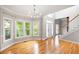 Open-concept living space featuring hardwood floors, large windows, and staircase access at 4016 Upland Trce, Marietta, GA 30066