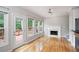 Bright living room with hardwood floors, fireplace, ceiling fan, and access to outdoor deck at 4016 Upland Trce, Marietta, GA 30066