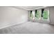 Spacious primary bedroom with tray ceilings, carpet, and bright, sunlit windows at 4016 Upland Trce, Marietta, GA 30066