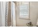 Bright bathroom featuring a tub with a decorative shower curtain and a window with stylish shutters at 4401 Madison Woods Nw Dr, Marietta, GA 30064