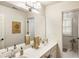 Well-lit bathroom with double sinks and views into another bathroom at 4401 Madison Woods Nw Dr, Marietta, GA 30064