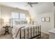 Cozy bedroom with a ceiling fan, neutral paint, and a large window with blinds at 4401 Madison Woods Nw Dr, Marietta, GA 30064