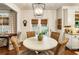 Stylish dining area with outdoor access and views, complemented by elegant light fixtures at 4401 Madison Woods Nw Dr, Marietta, GA 30064